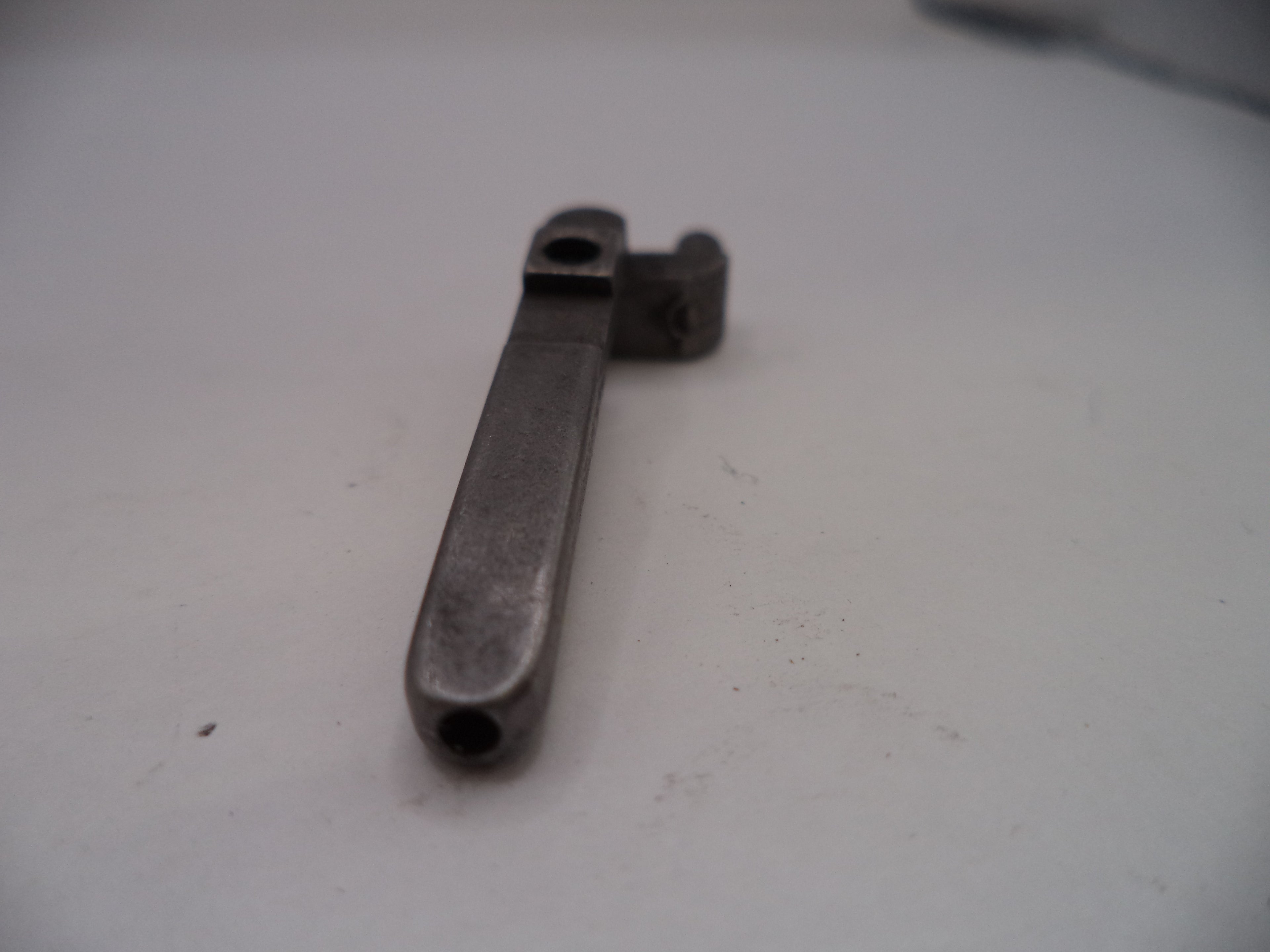 Metal wrench on a white surface