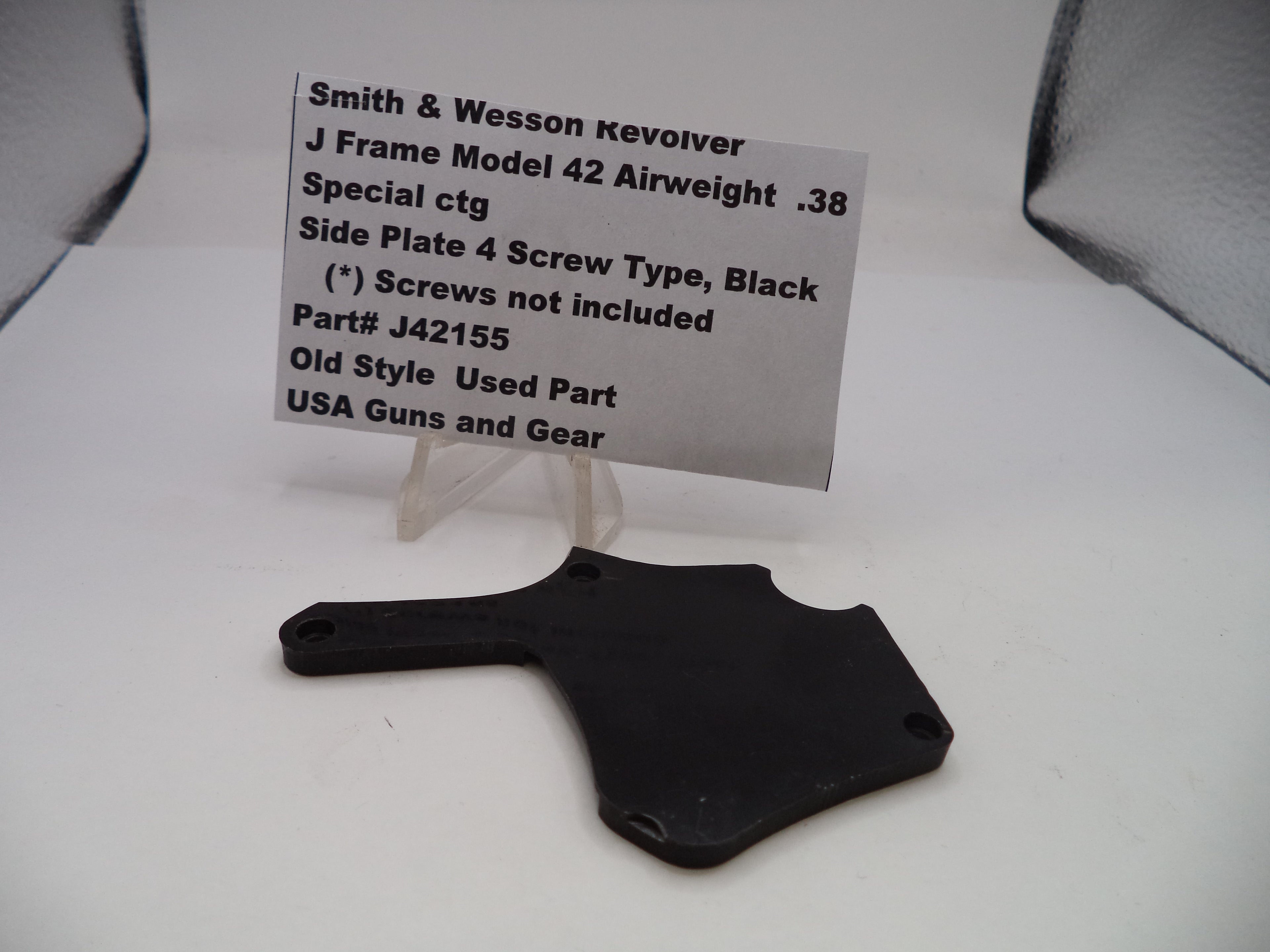 Black side plate for a Smith & Wesson revolver on a white background with descriptive text card.