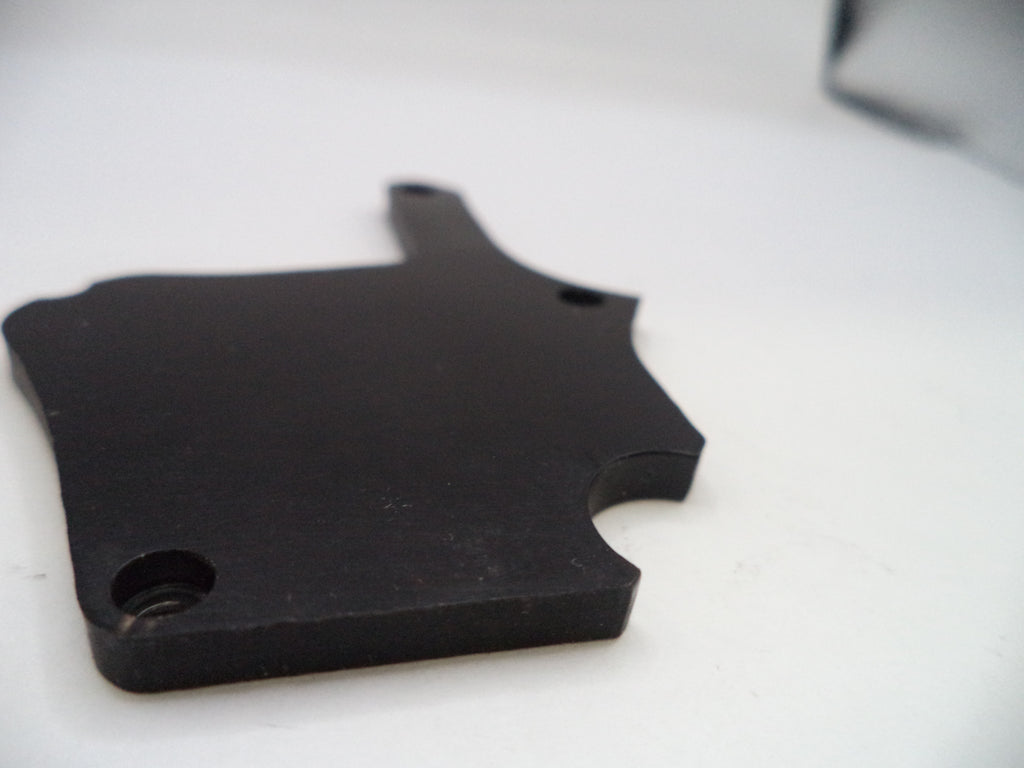 Black puzzle piece-shaped object on a white background