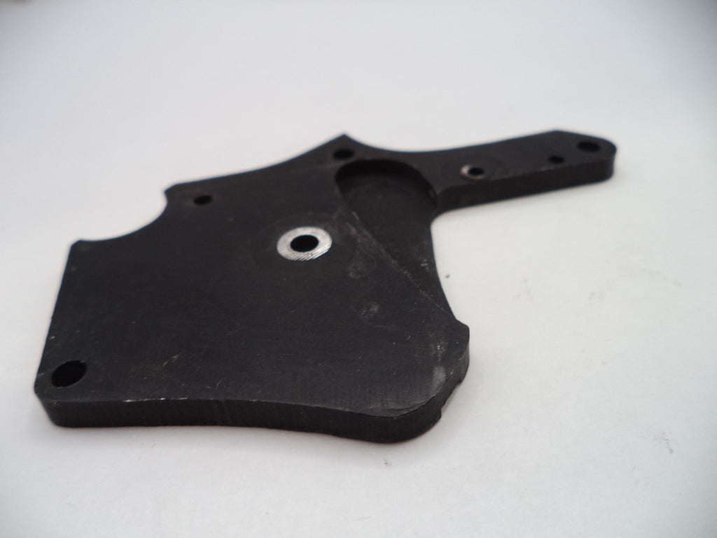 Black plastic component on a white background