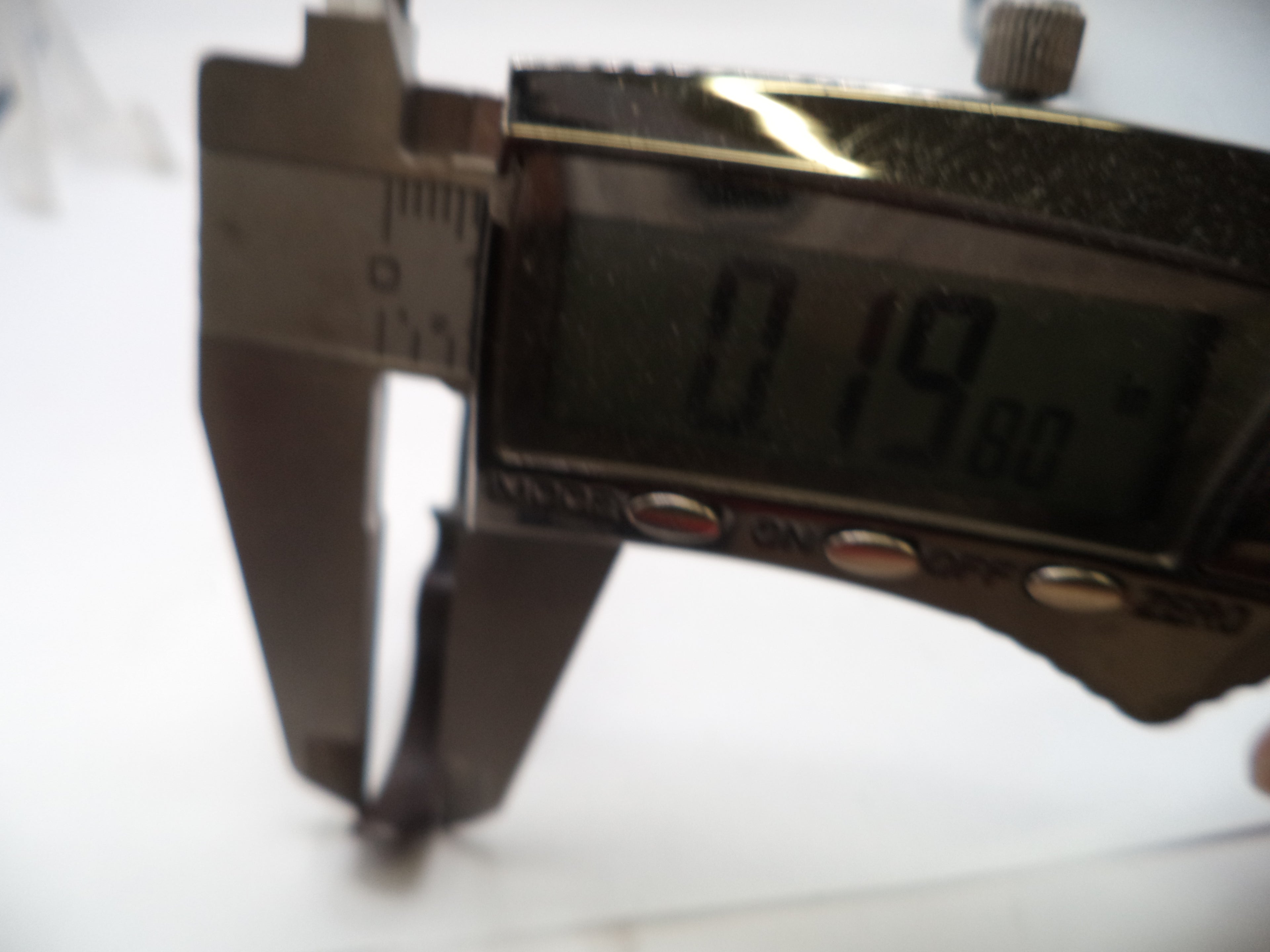 Digital caliper showing a measurement on a white background