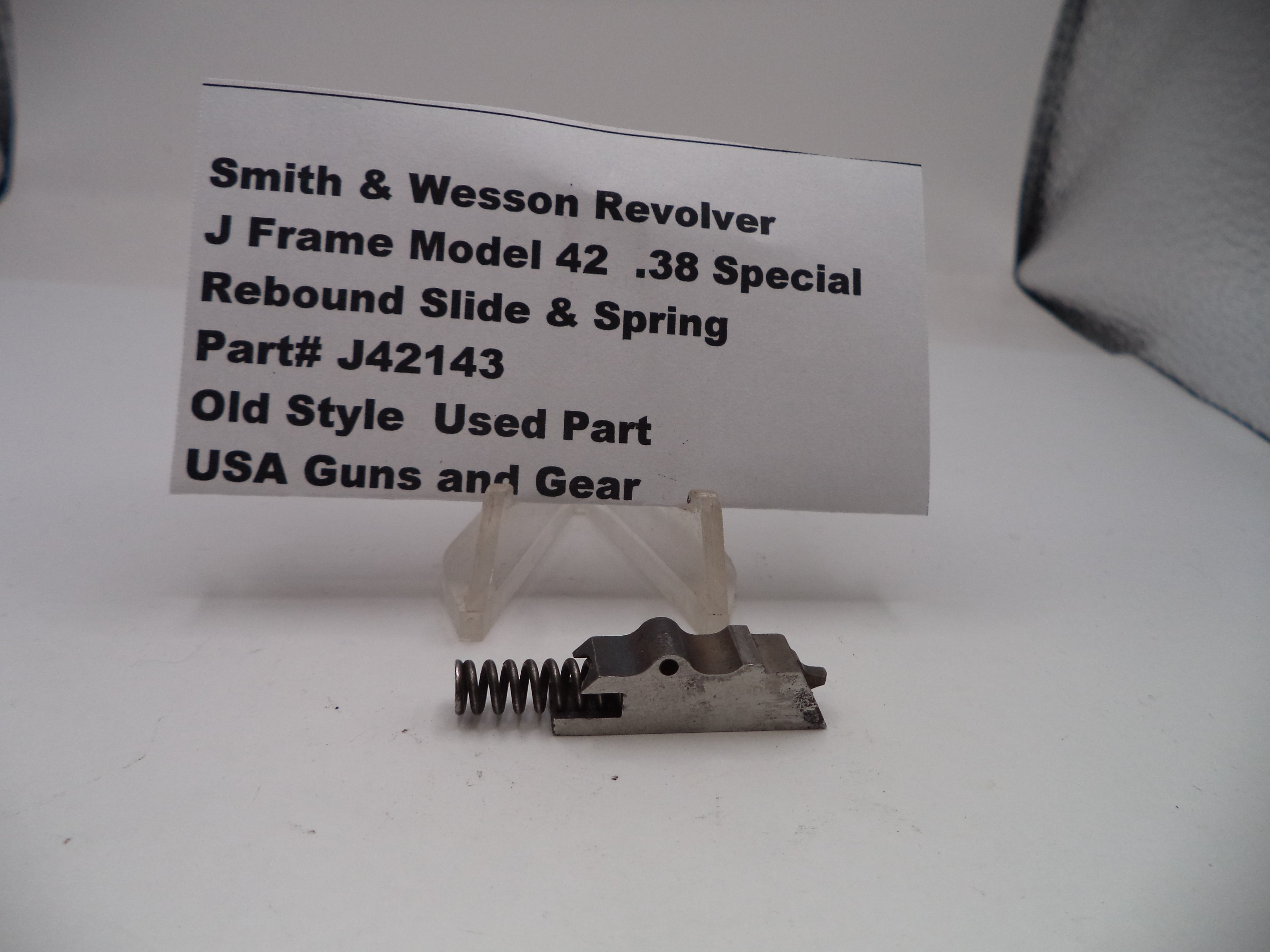 Smith & Wesson Revolver J Frame Model 42 .38 Special Rebound Slide & Spring part on a white background with a label.