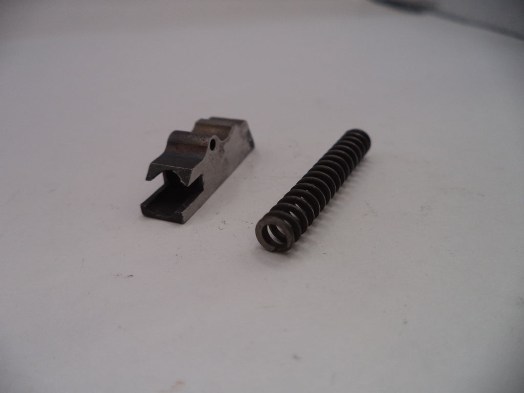 Metal spring and metal component on a white surface