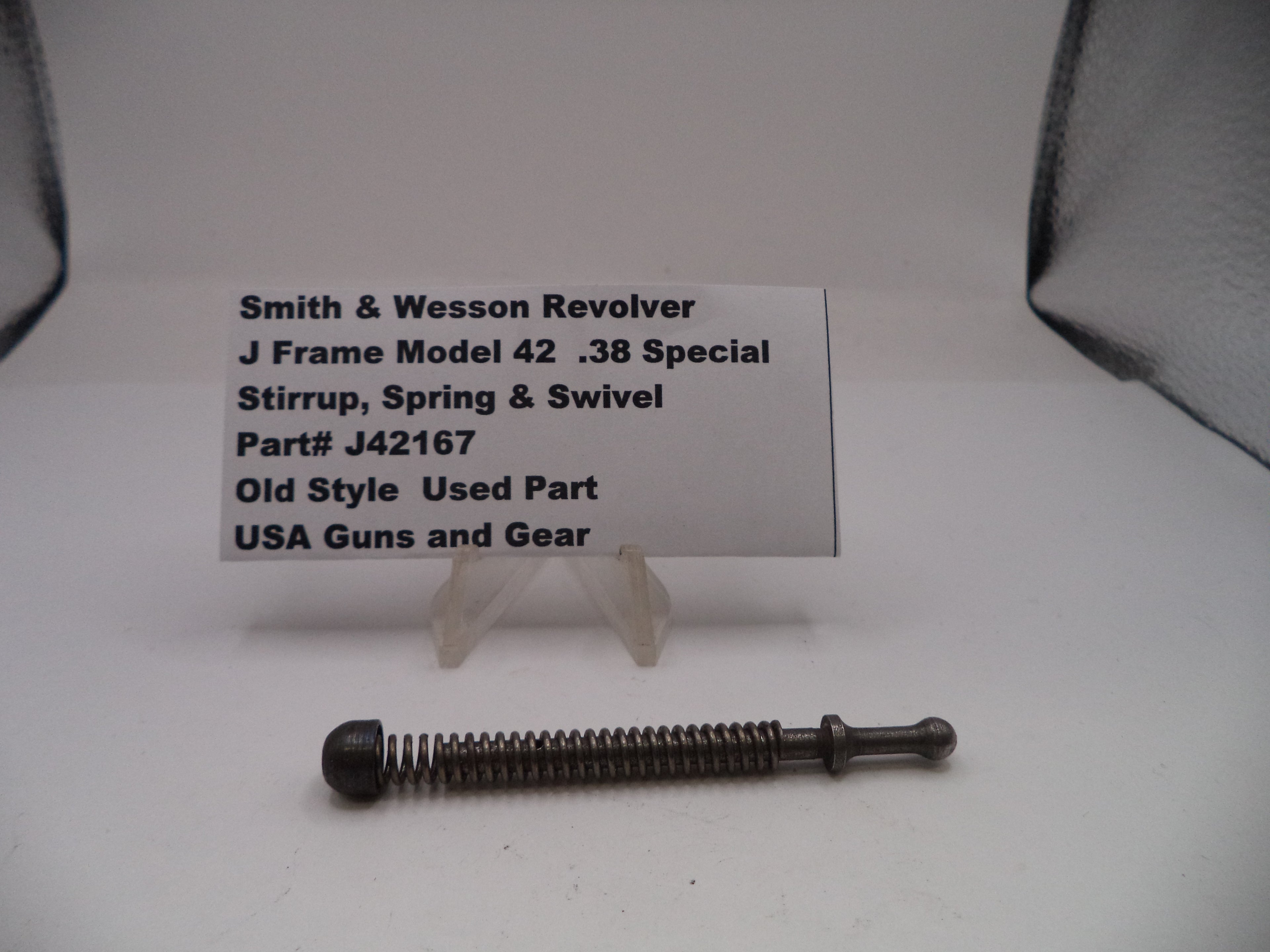 Smith & Wesson revolver part on a white background with a label