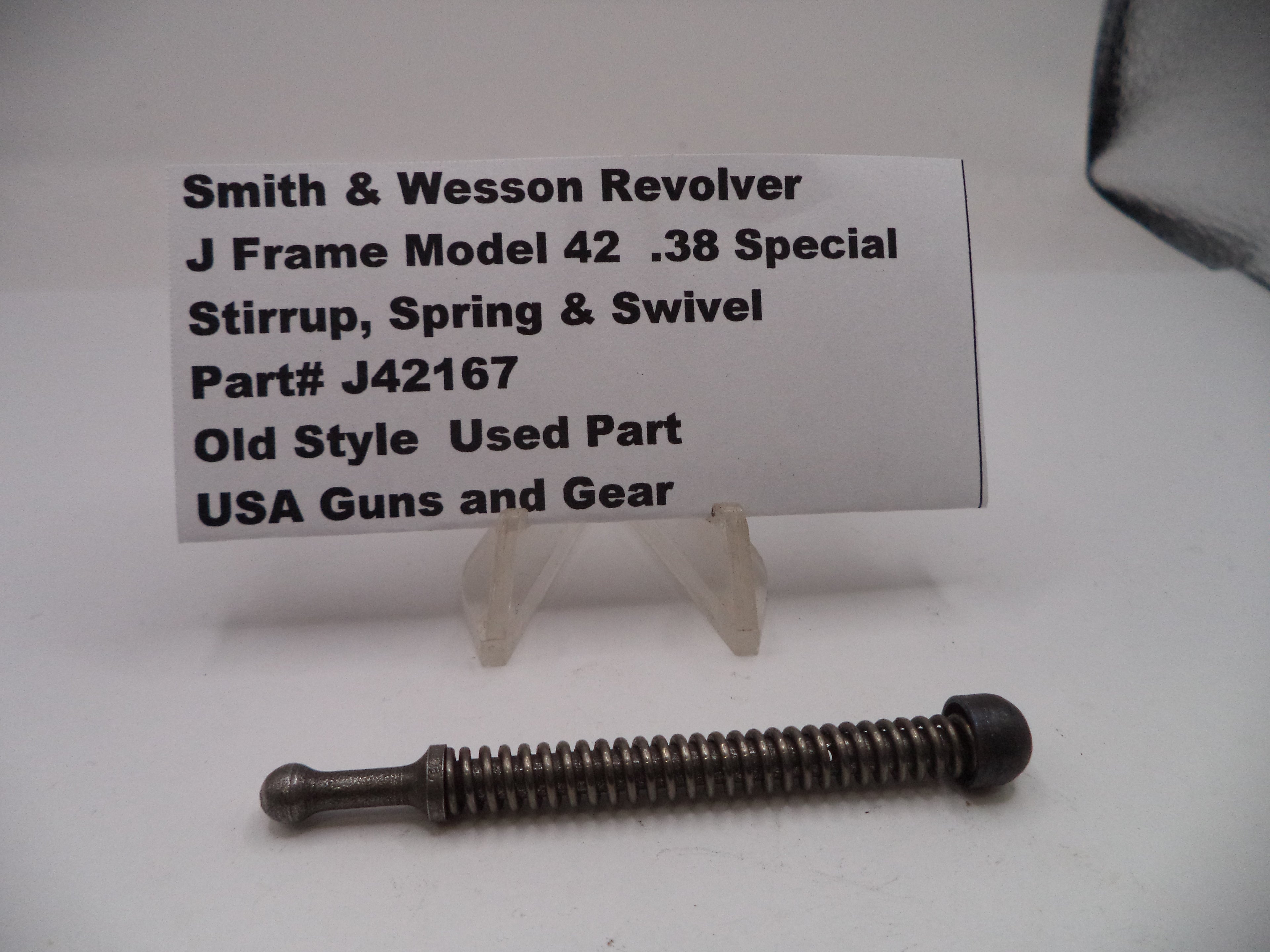 Smith & Wesson revolver part with descriptive card on a white background