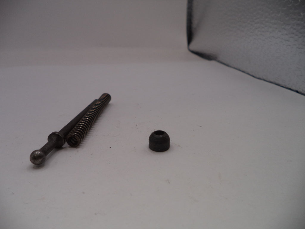 Two metal screws on a white surface with a gray textured background