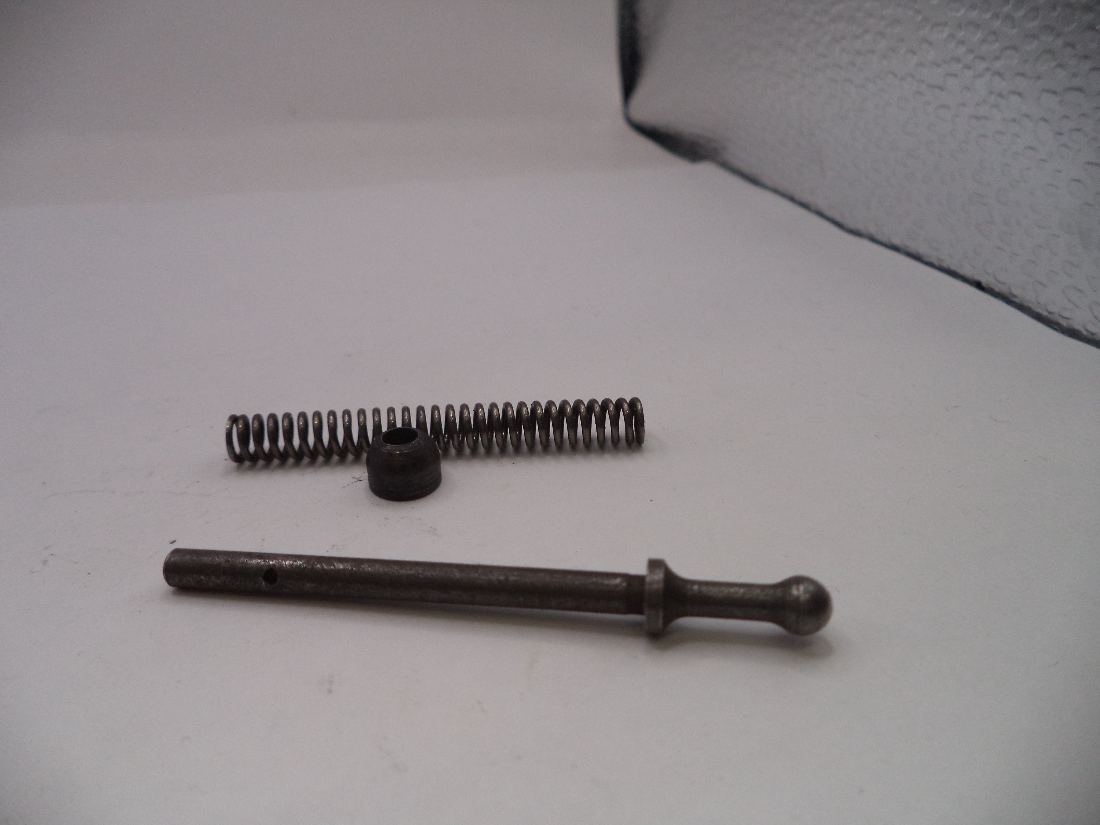 Two metal springs on a light gray surface
