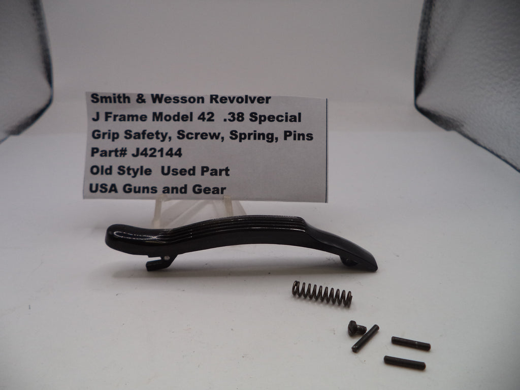 Smith & Wesson revolver part with screws and spring on a white background