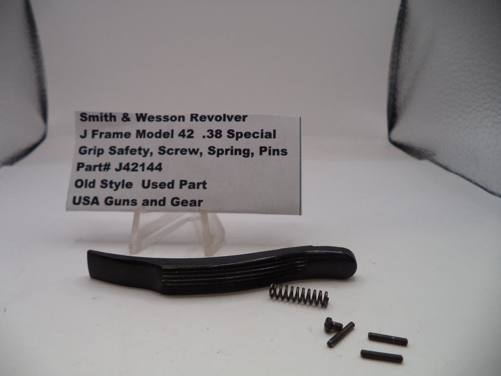 Smith & Wesson revolver parts including a grip safety, screw, spring, and pins on a white background with a label.