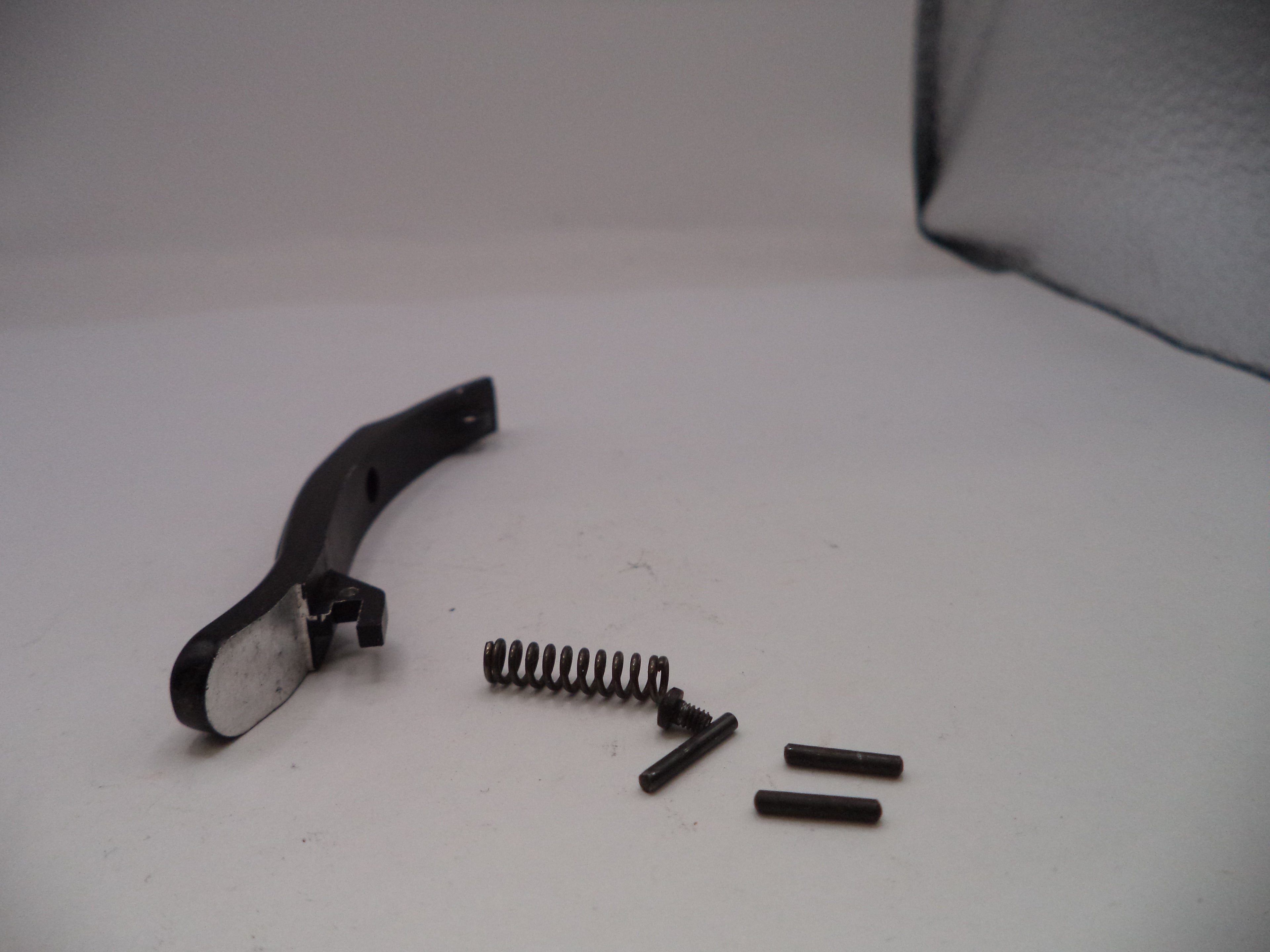 Black metal bracket with springs and screws on a white surface