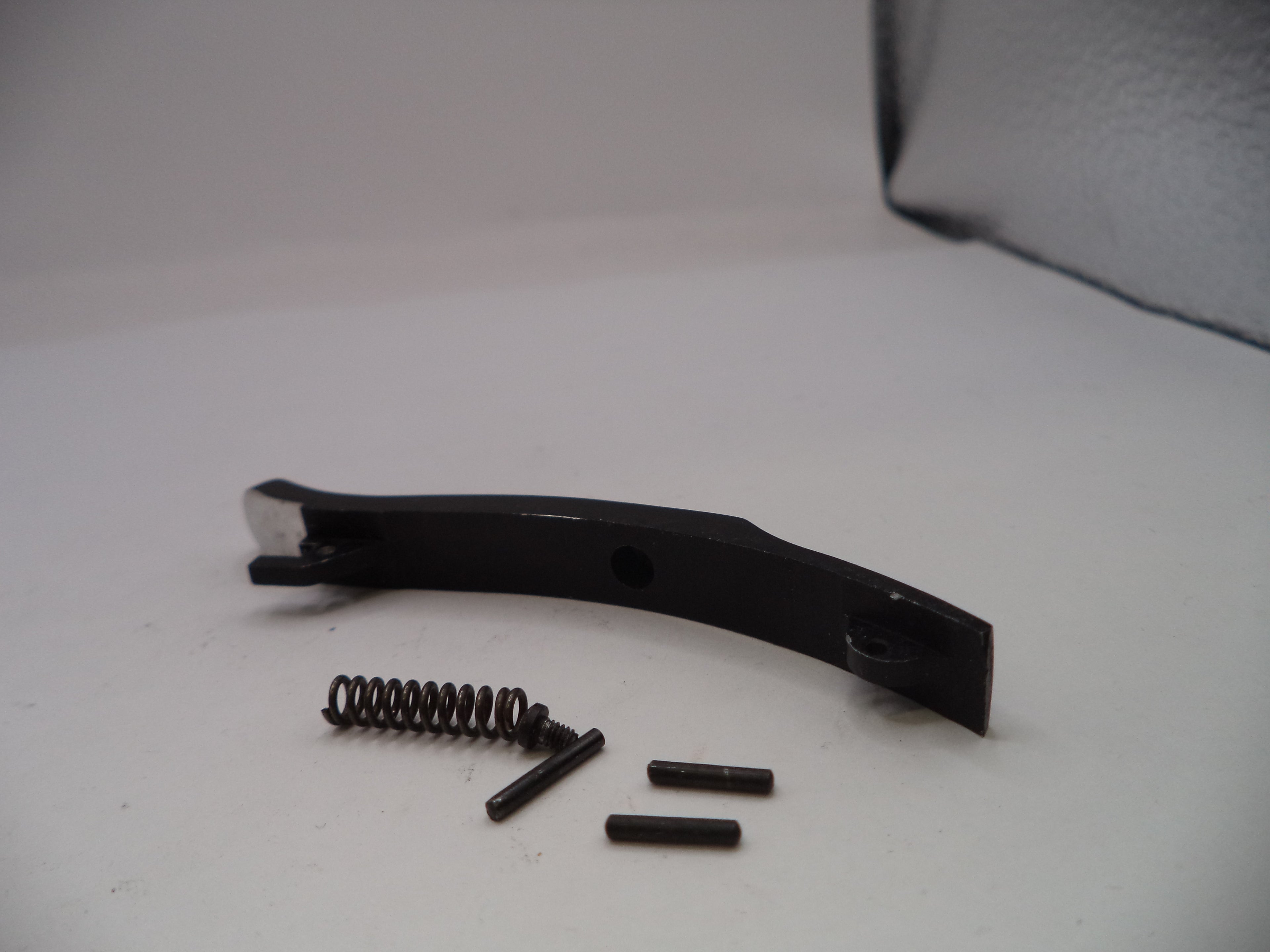 Black metal bracket with springs and screws on a white surface