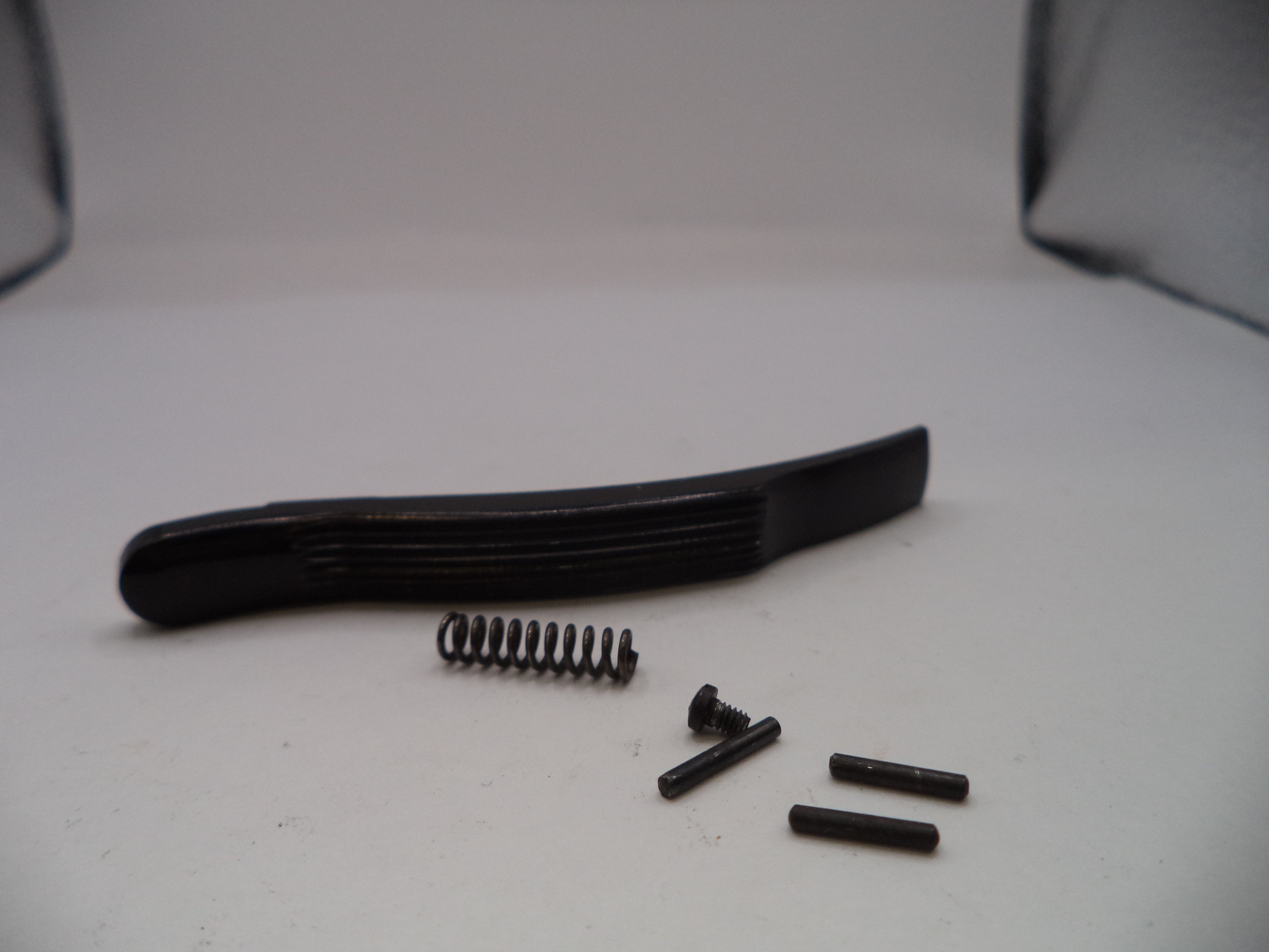 Black plastic component with screws on a white background