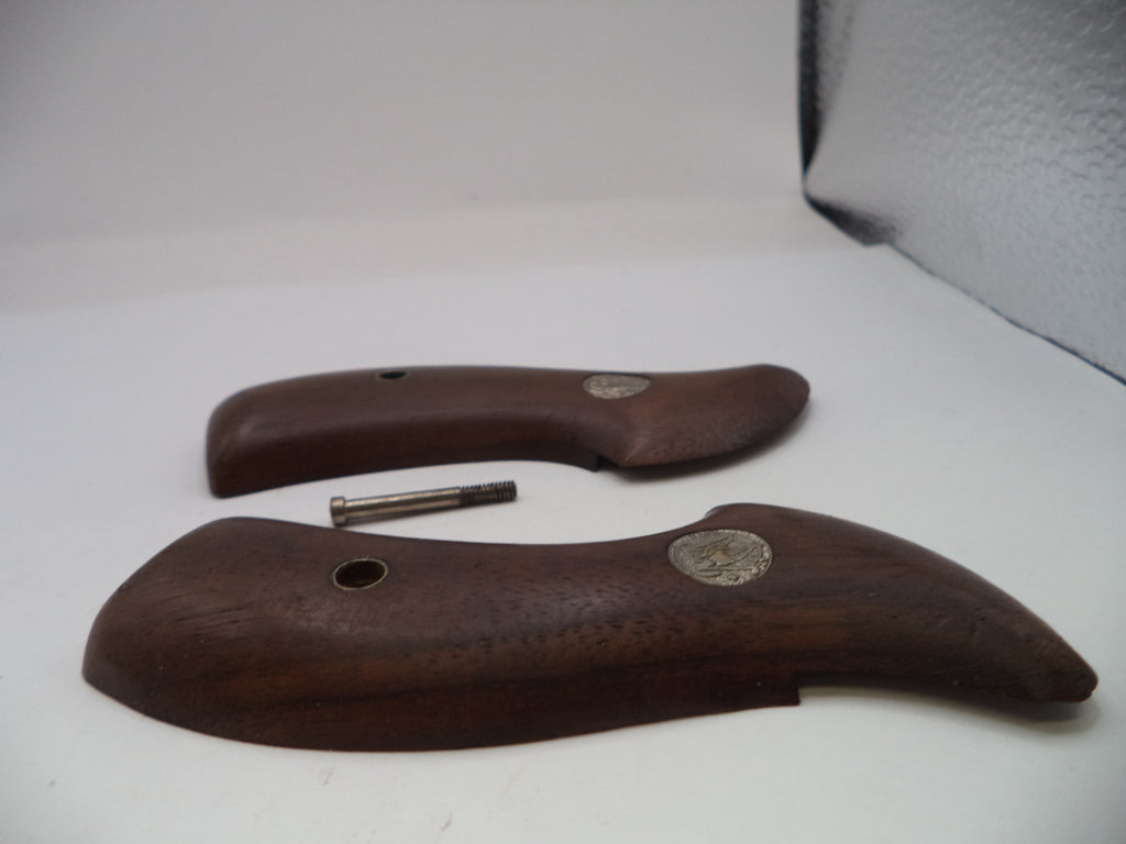 Two brown wooden handles with metal pins on a white surface