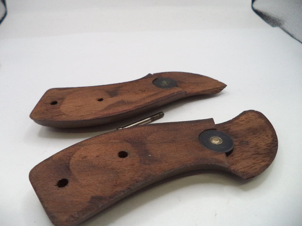 Two wooden knife handles on a white surface