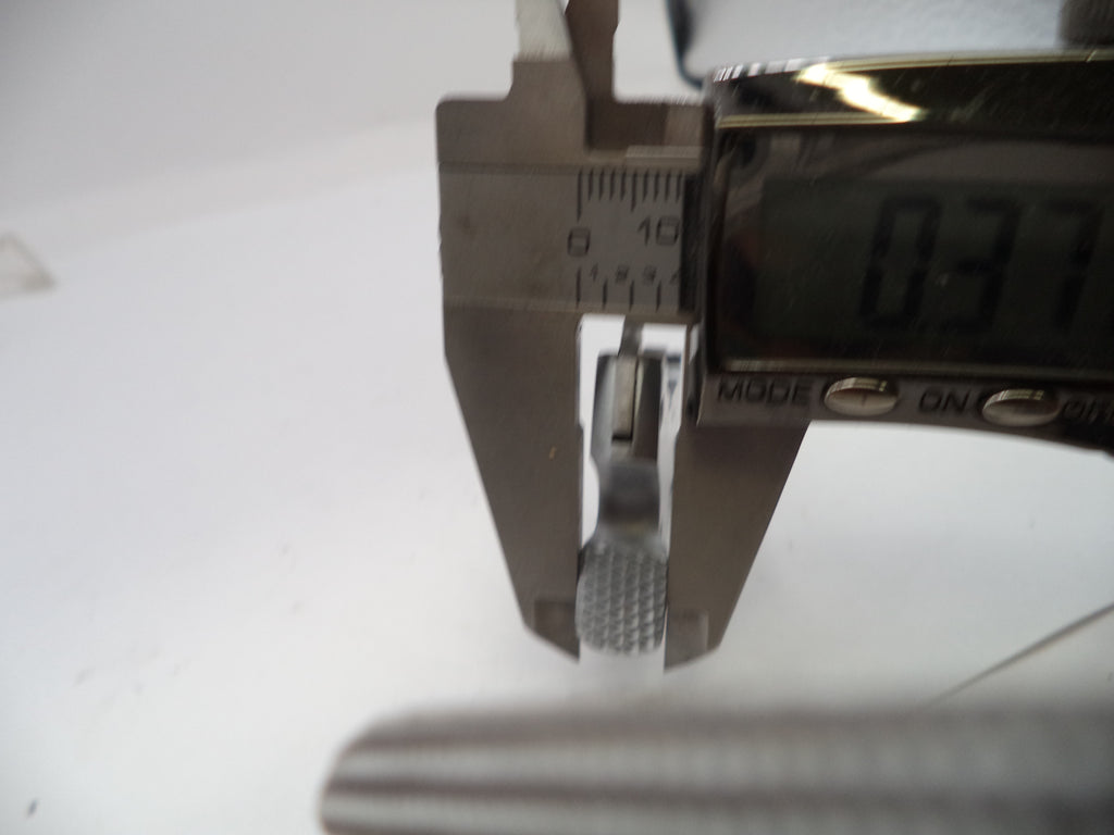 Digital caliper measuring a small object with a white background