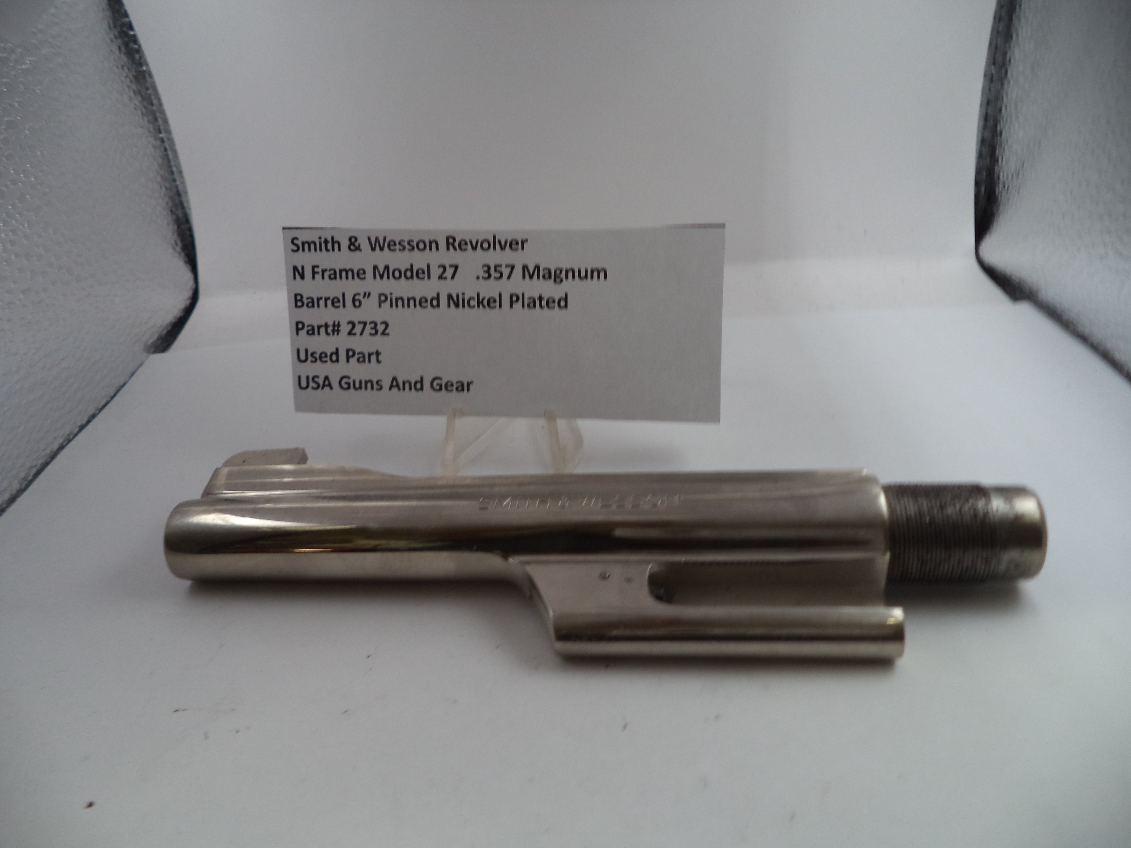 Smith & Wesson revolver barrel on a white background with a label.