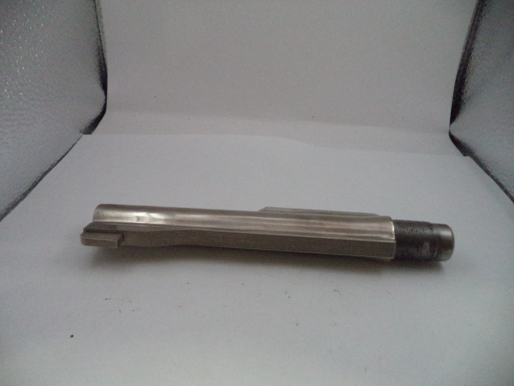 Metal tool or component on a white surface