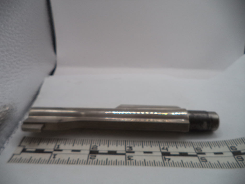 Metal tool or component on a white surface with a ruler for scale.