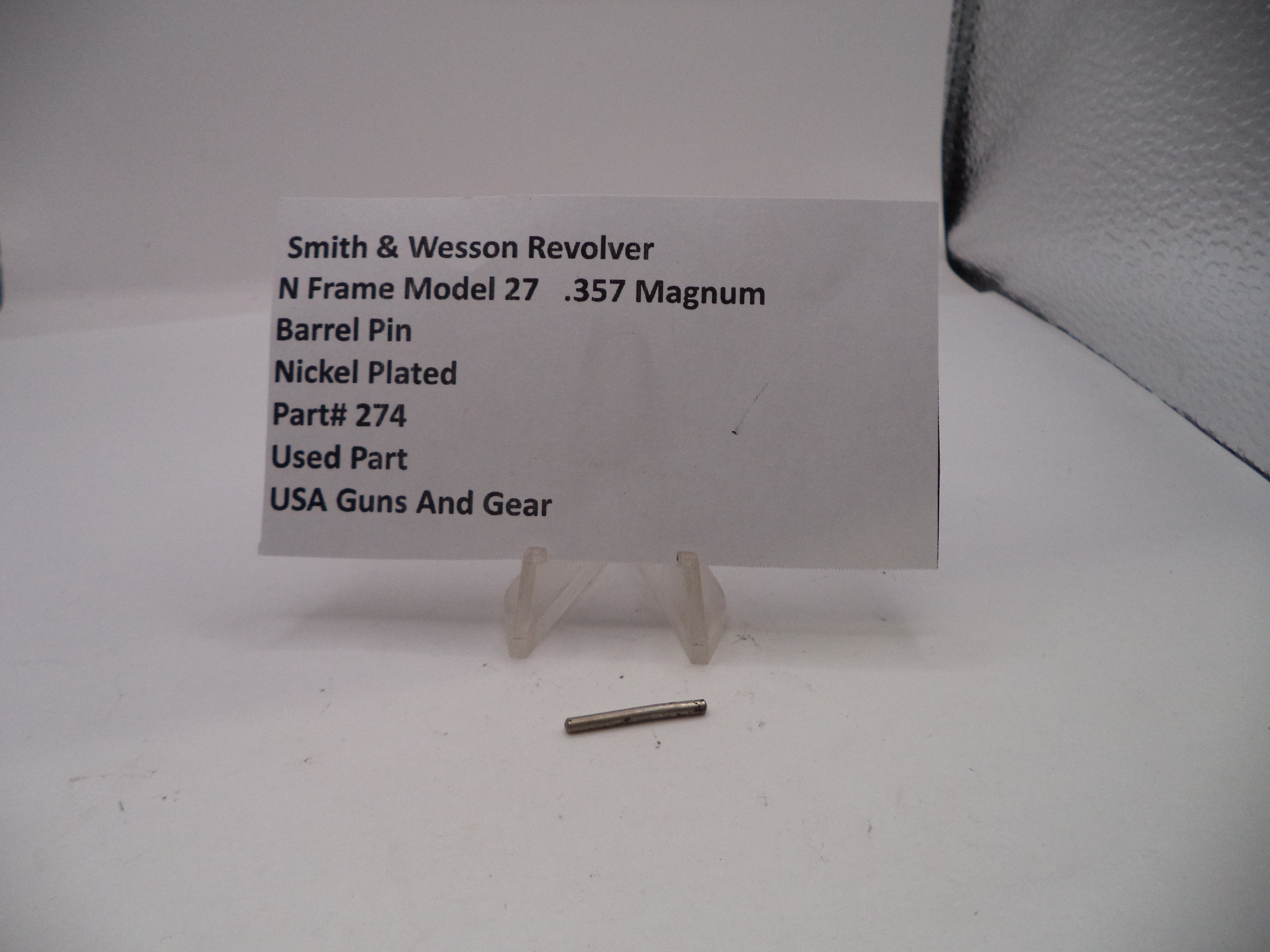 Smith & Wesson revolver barrel pin with a label on a white background