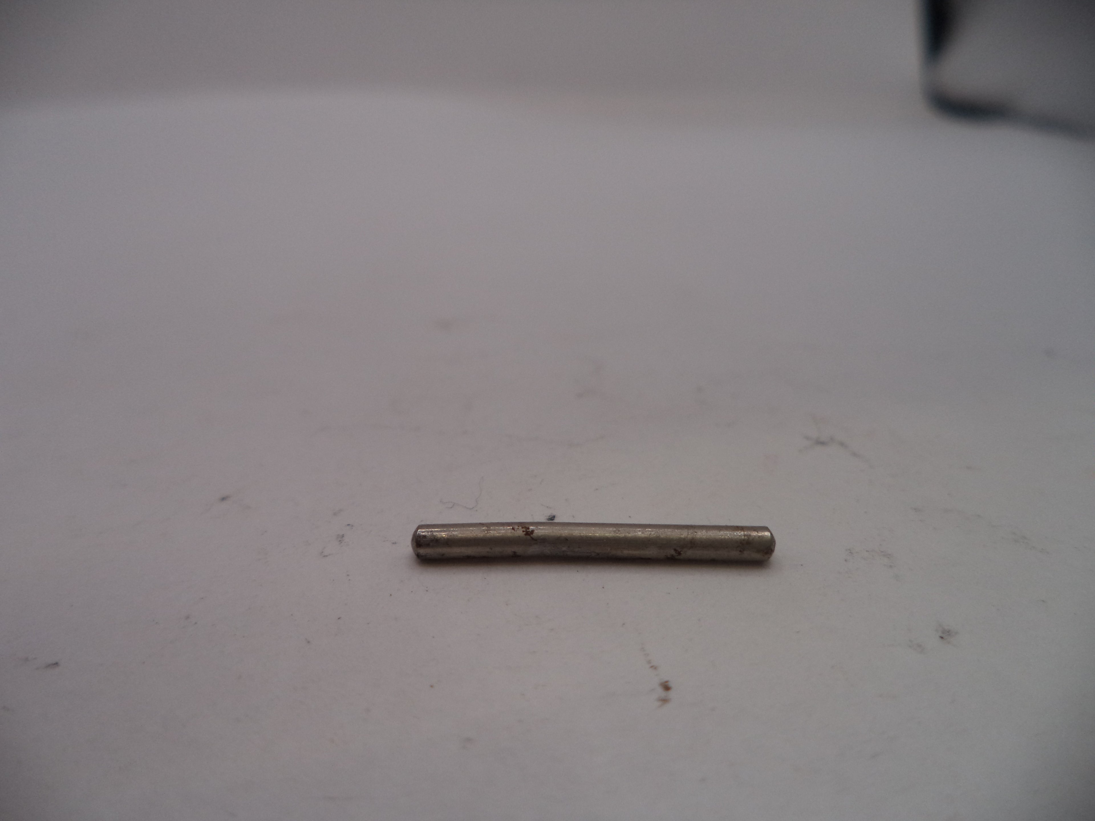 Small cylindrical metal object on a white surface