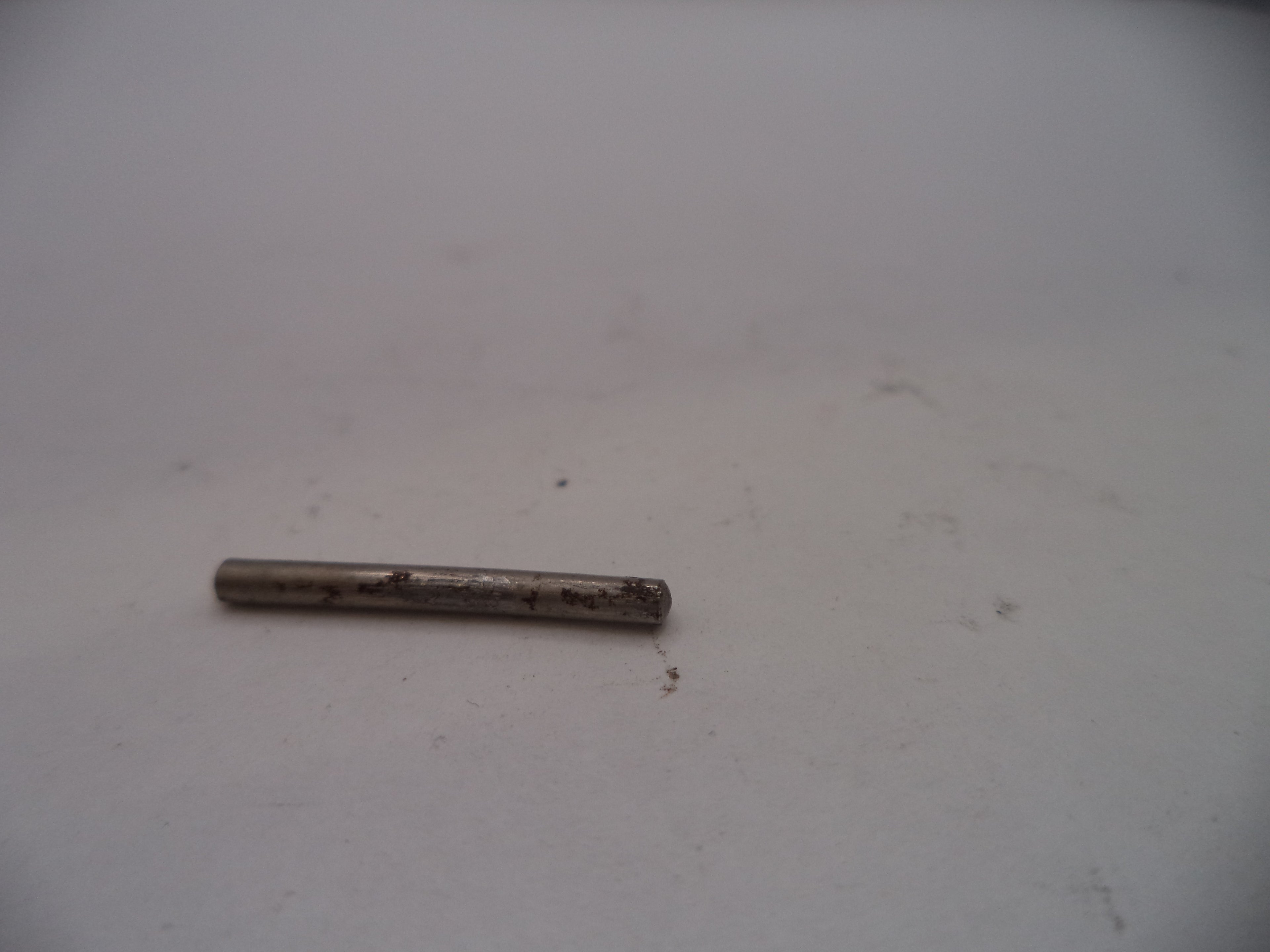 Small cylindrical metal object on a white surface