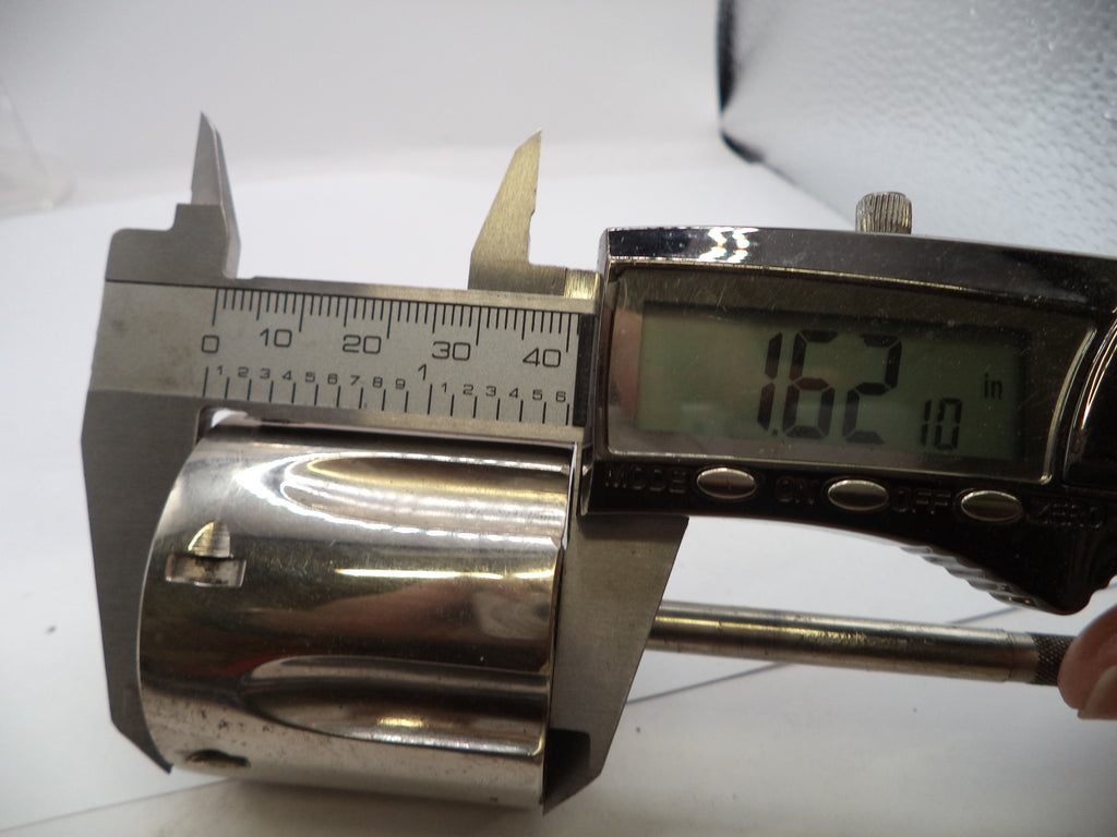 Metallic cylindrical object being measured with a digital caliper on a white background