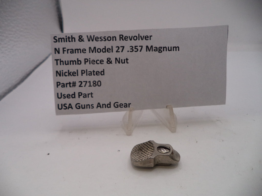 Smith & Wesson revolver thumb piece & nut on a white background with a label.