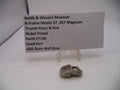 Smith & Wesson revolver thumb piece & nut on a white background with a label.