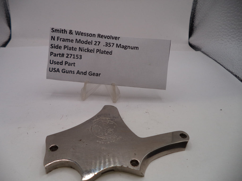 Smith & Wesson revolver side plate on a white background with a label