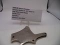 Smith & Wesson revolver side plate on a white background with a label
