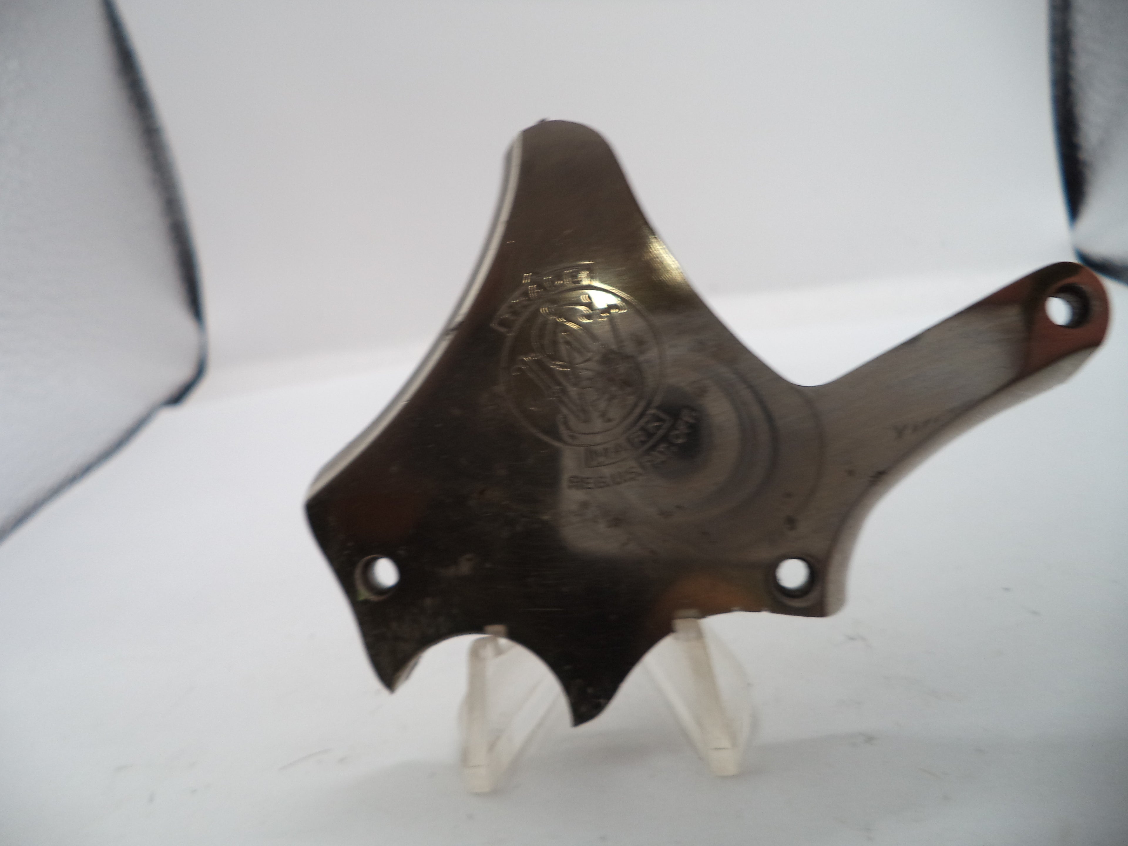 Metallic object with a logo on a white background