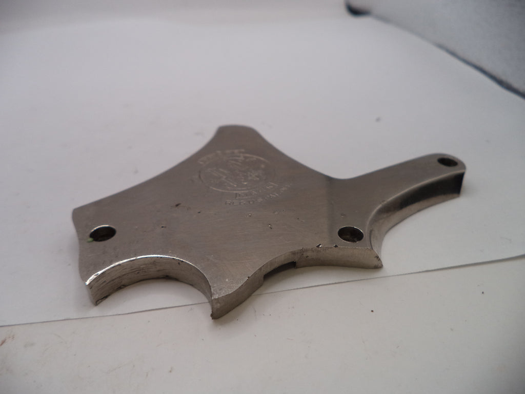 Metal tool or component on a white surface