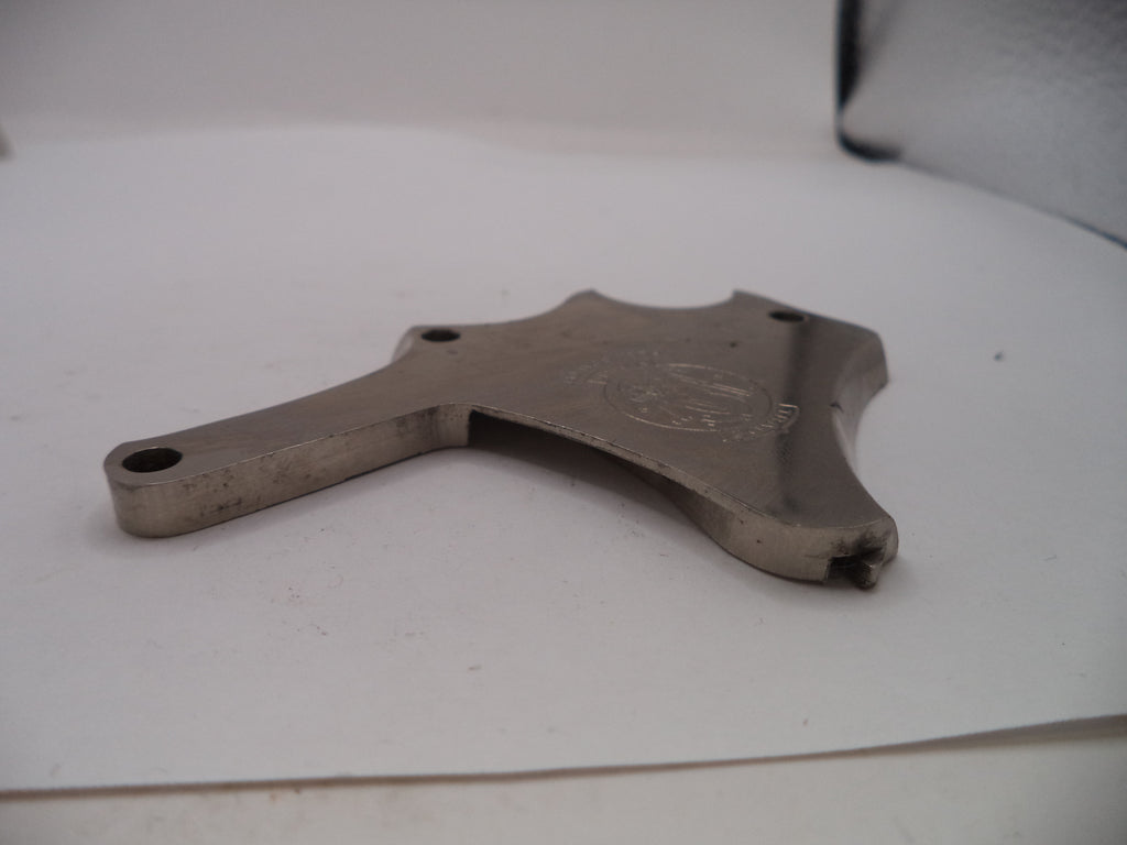 Metallic object with engraved design on a white surface