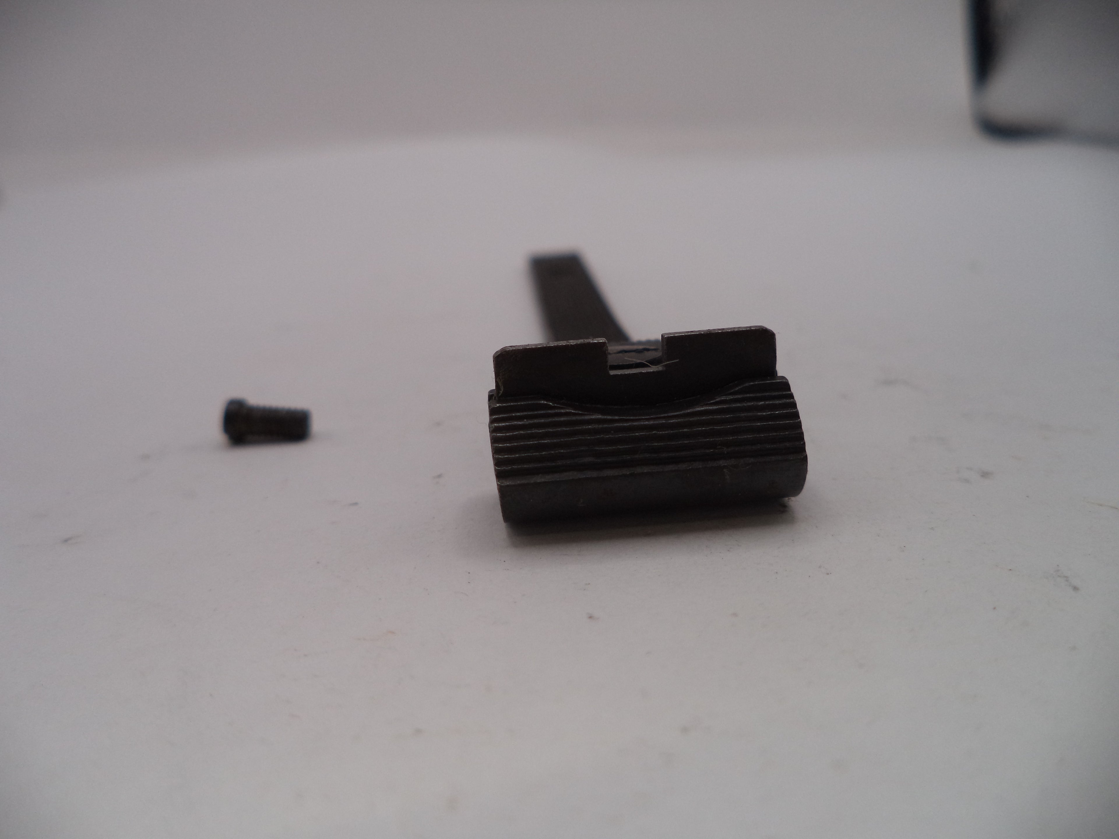 Black metal component on a white surface