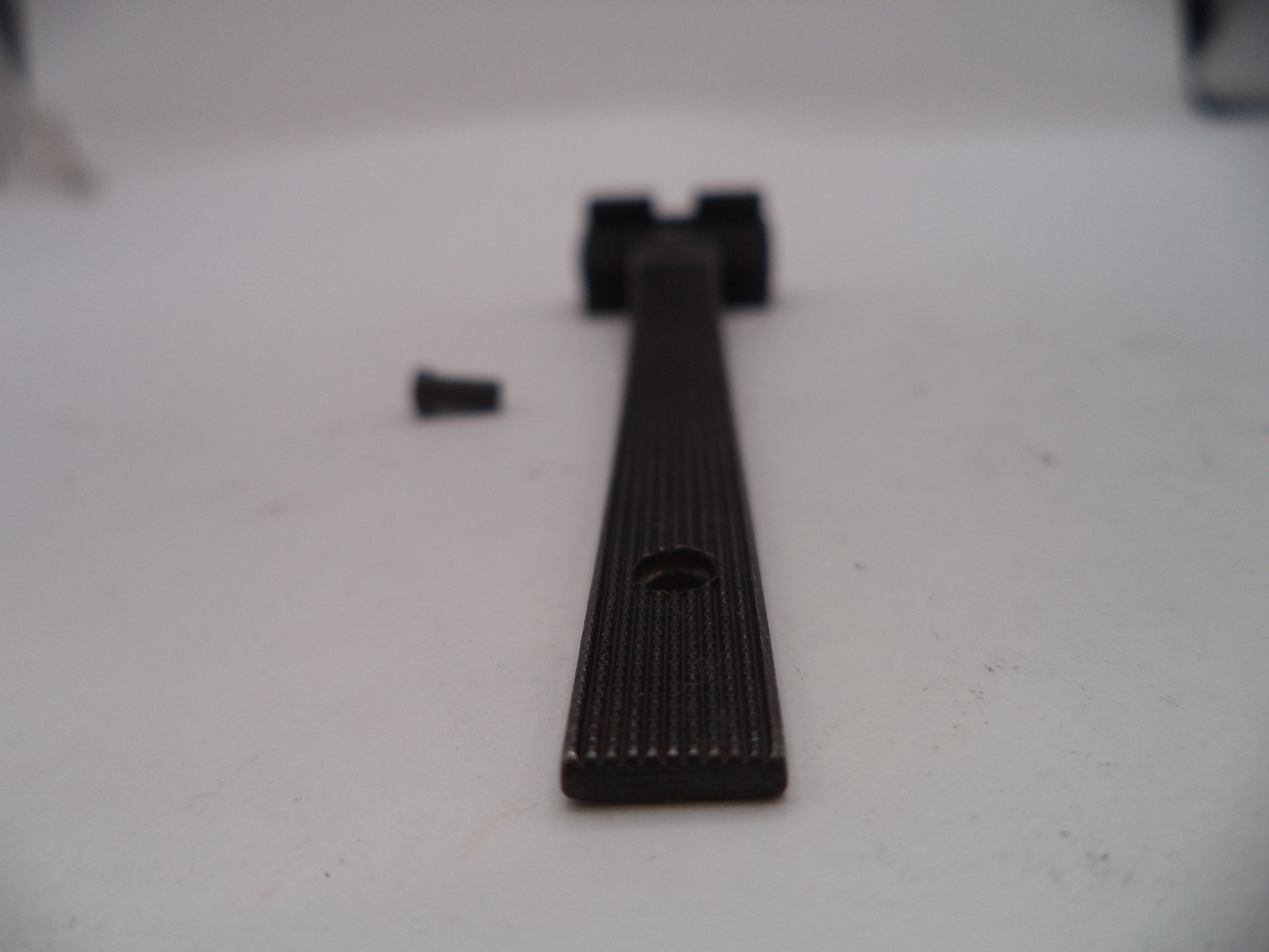 Black metal bar on a white surface