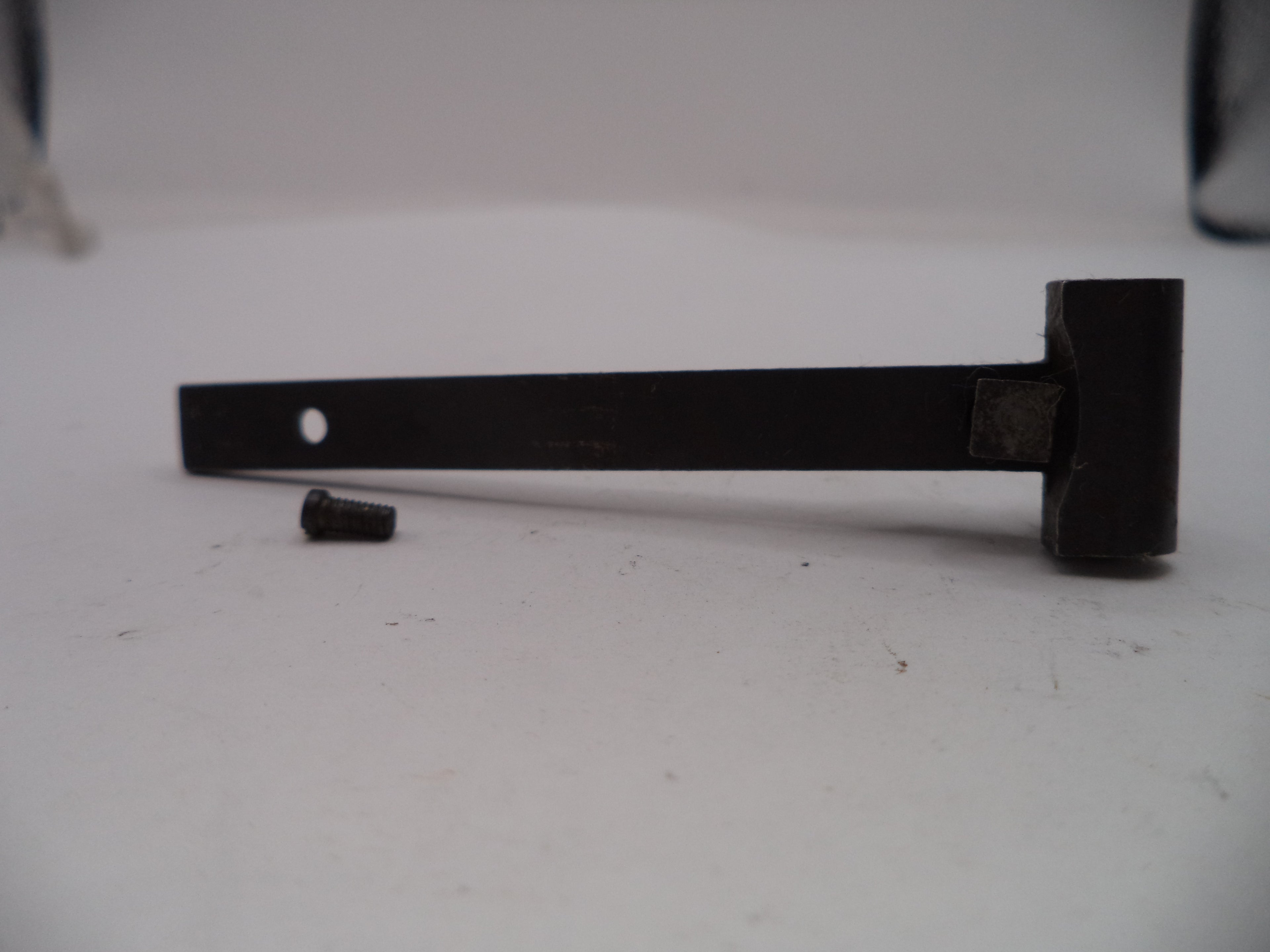 Black metal bracket on a white surface