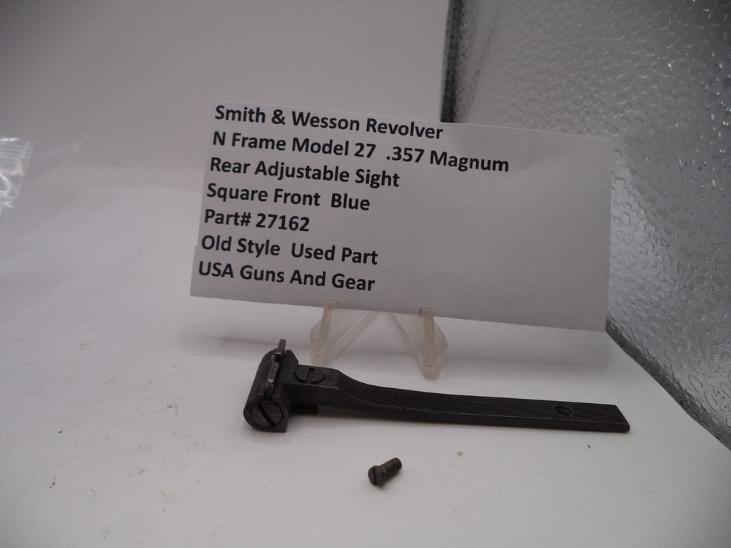 Smith & Wesson revolver rear adjustable sight on a white surface with a label.