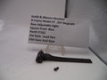 Smith & Wesson revolver rear adjustable sight on a white surface with a label.