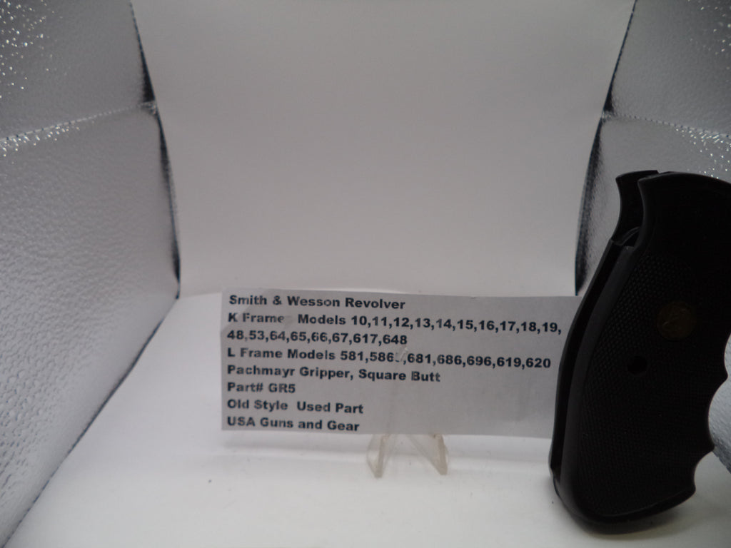 Black gun grip on a white card with text in a gray box