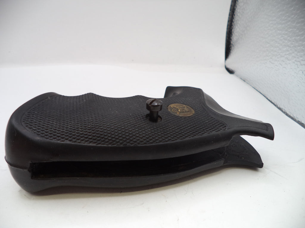 Black gun stock on a white surface