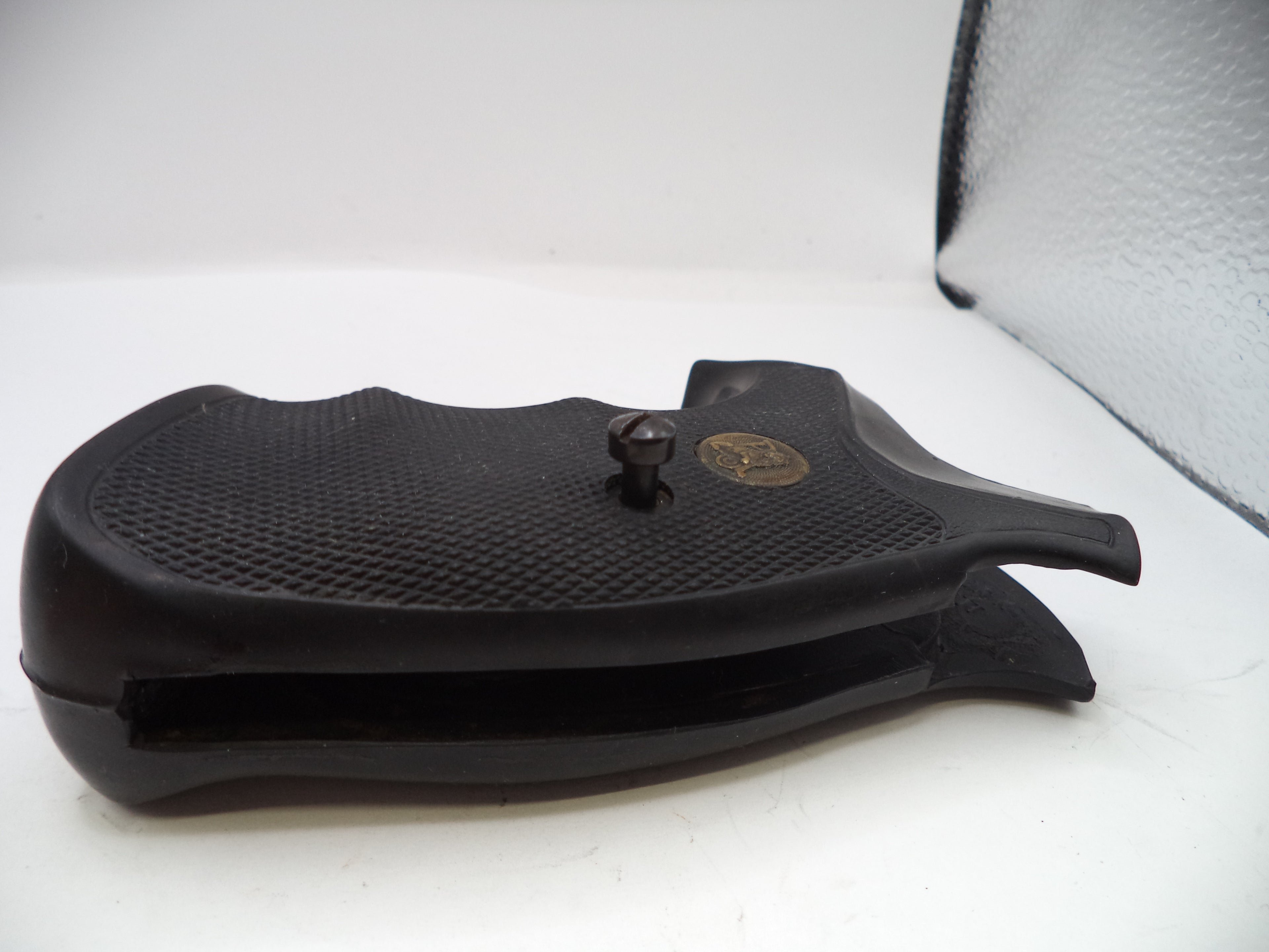 Black gun stock on a white surface