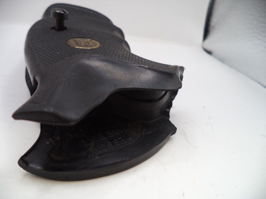 Black revolver and holster on a white background