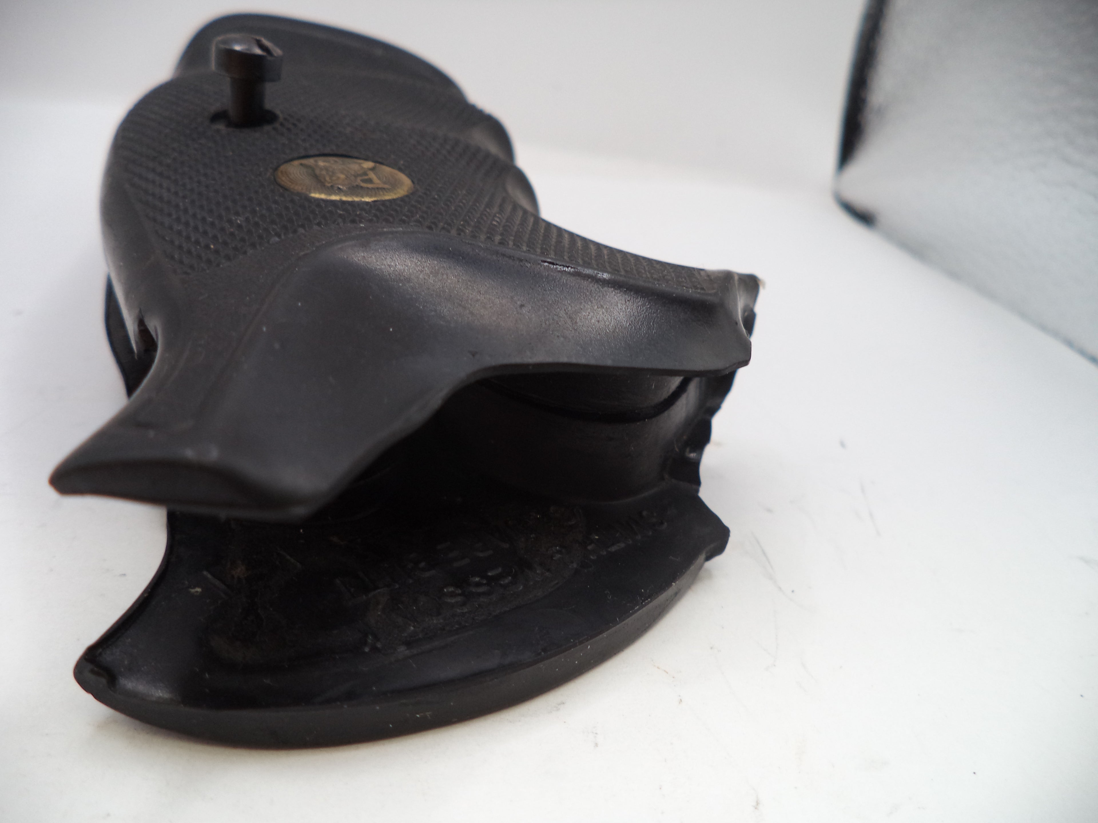 Black revolver and holster on a white background