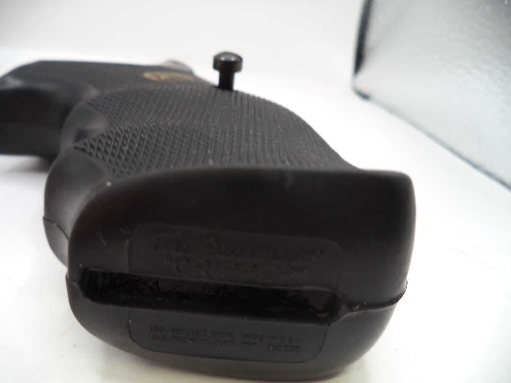 Close-up of a black firearm grip on a white background