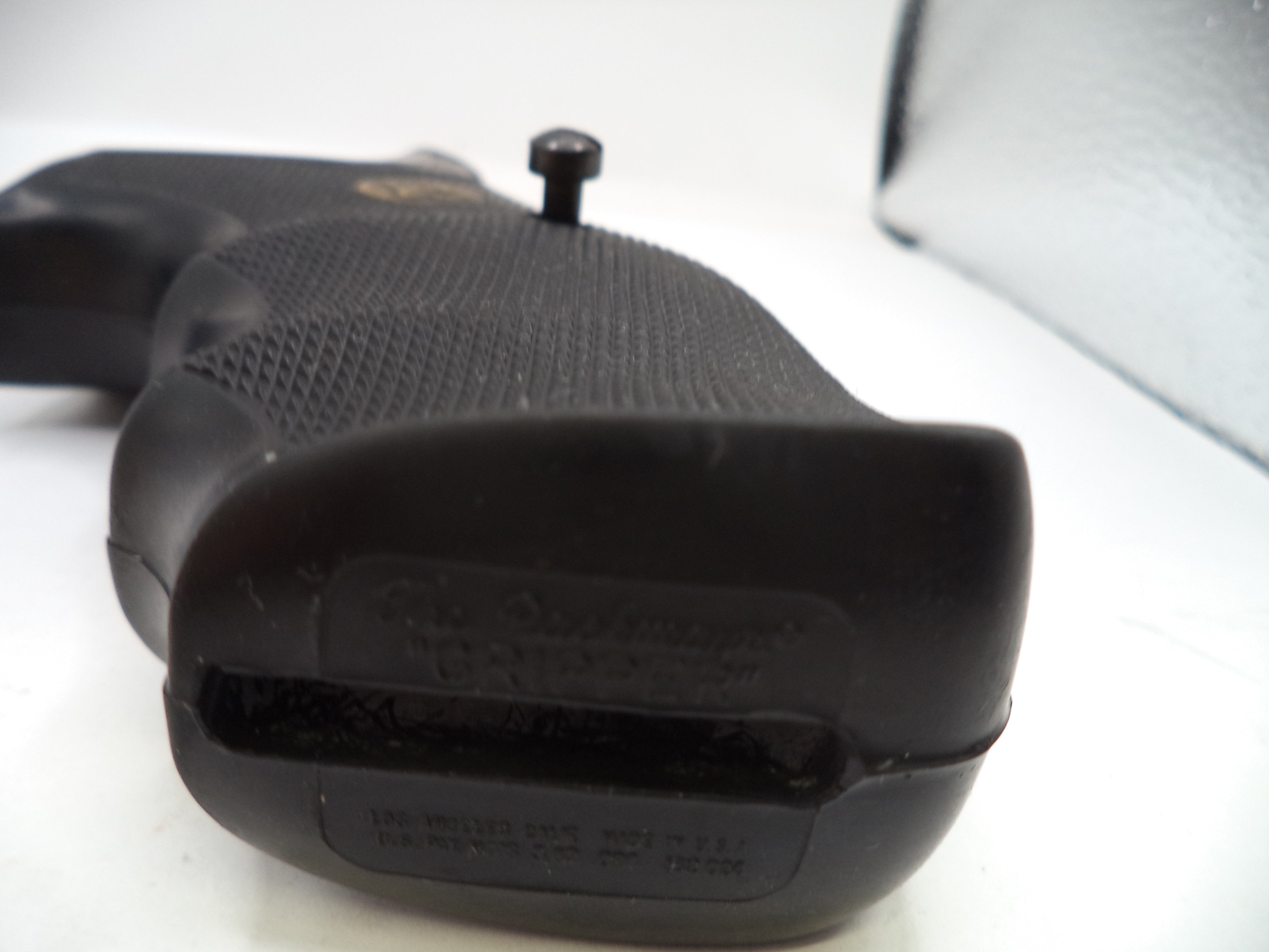 Close-up of a black firearm grip on a white background