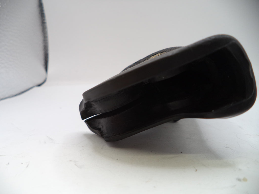Black plastic component on a white background