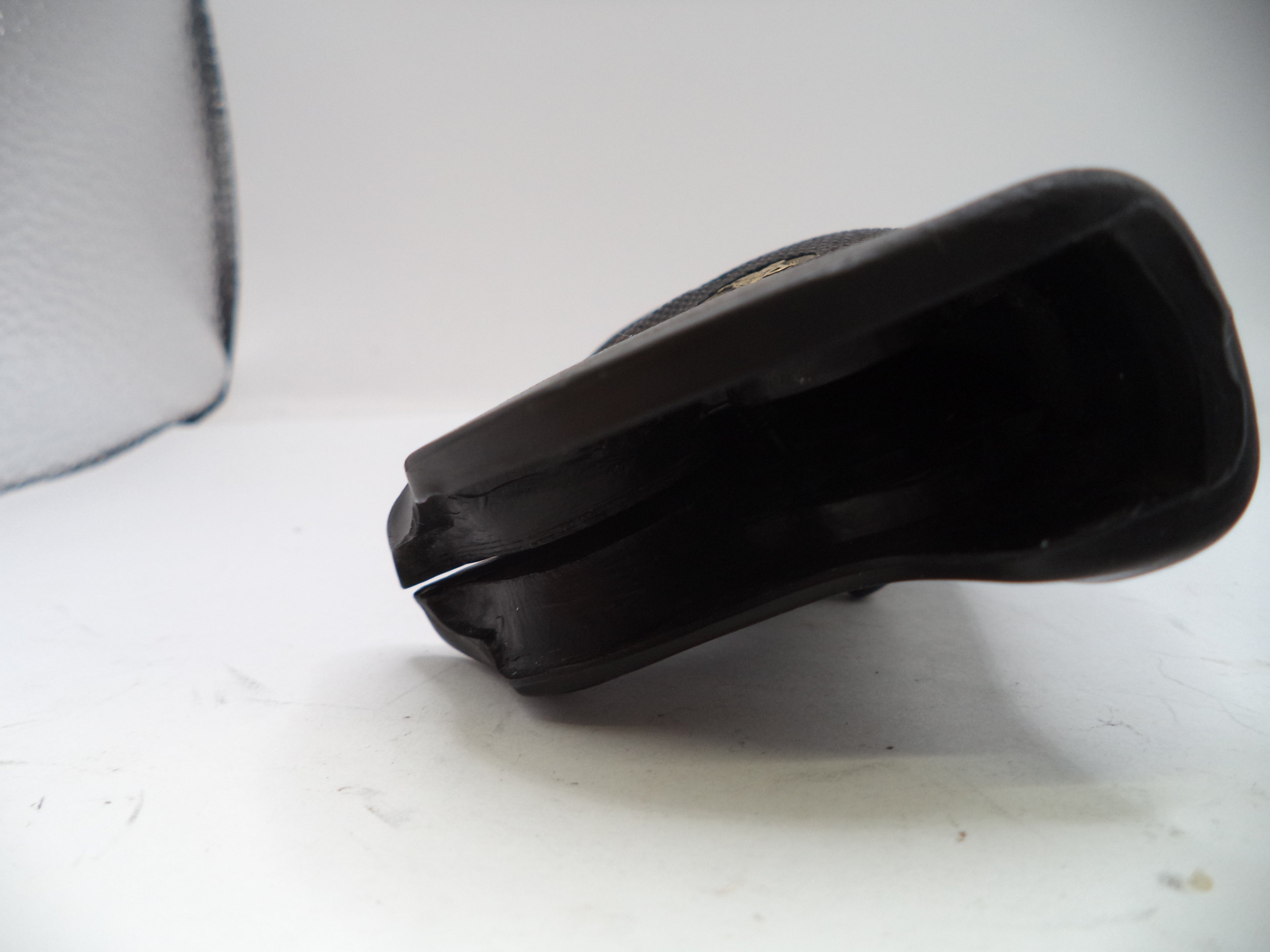 Black plastic component on a white background