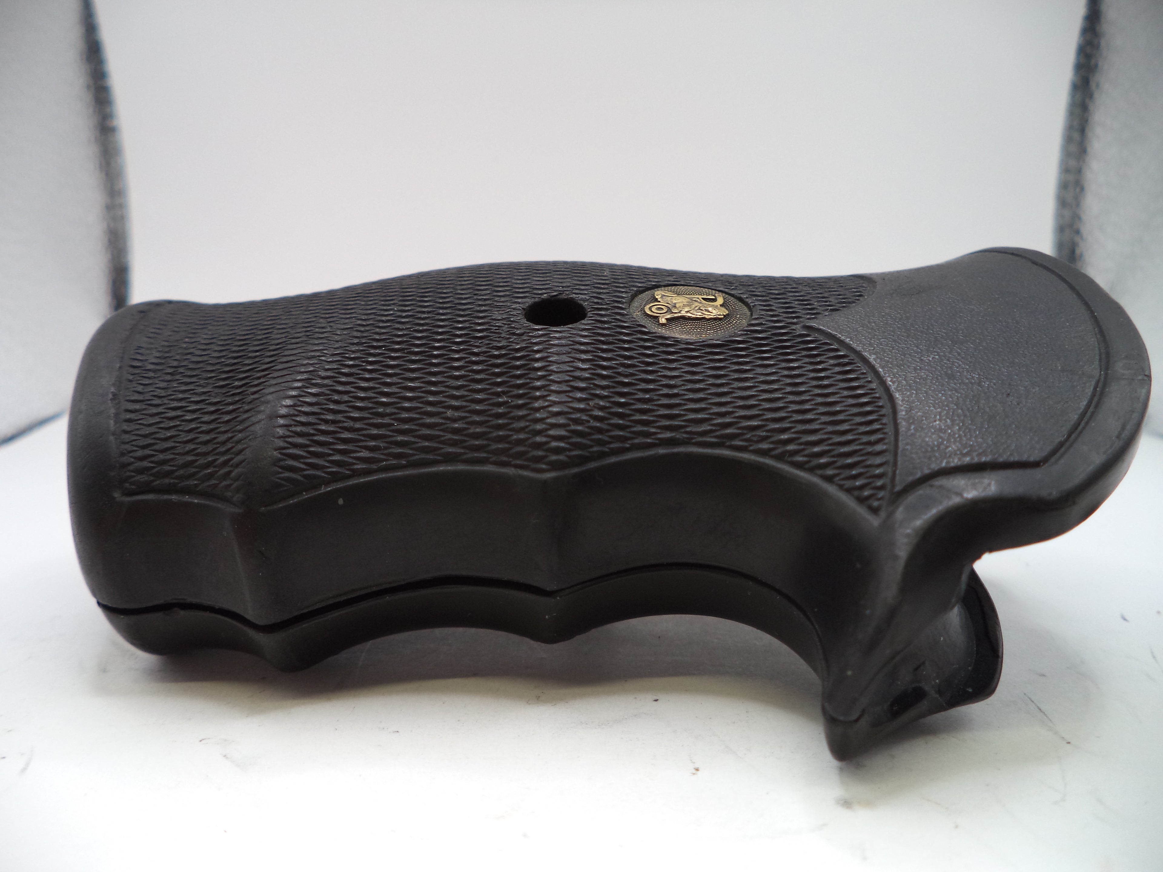 Black gun grip with a brand logo on a white background