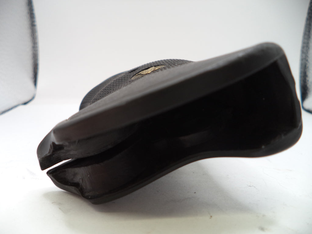 Black shoe sole on a white surface with a blurred background