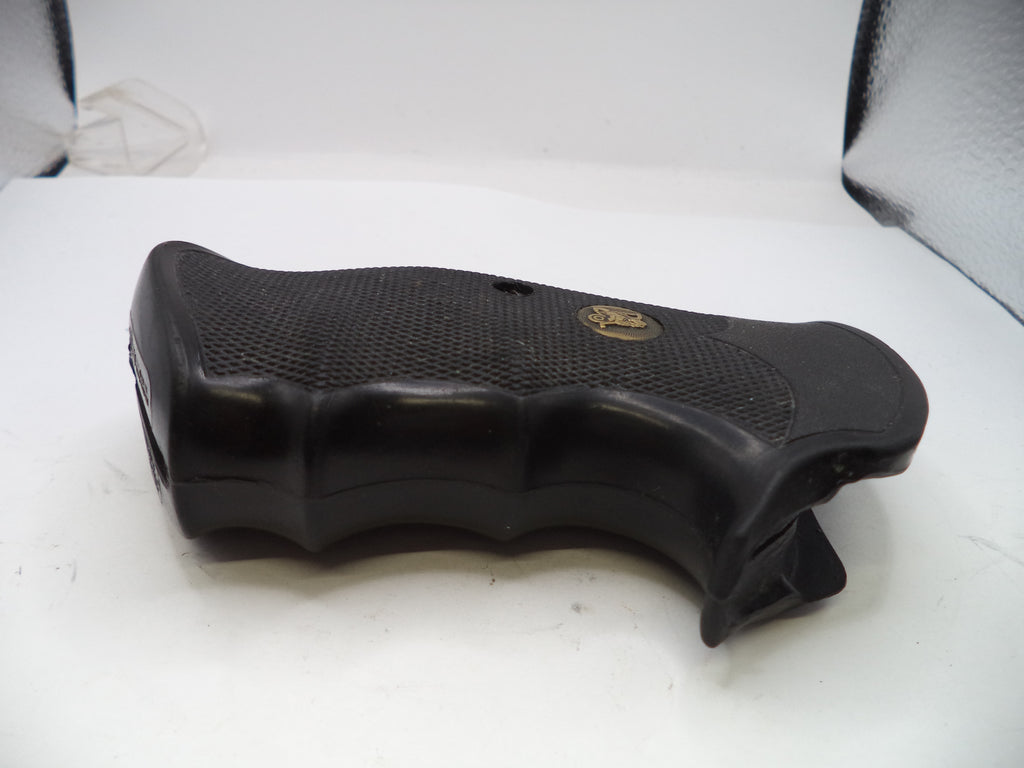 Black gun grip on a white surface